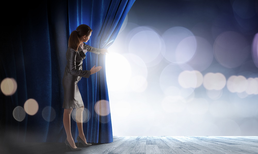 Woman peering through event curtain